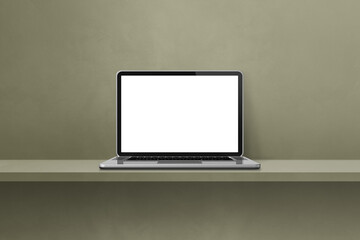 Laptop computer on green shelf background