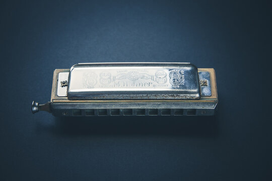 Vintage M. Hohner harmonica isolated on a black background, Paris, France