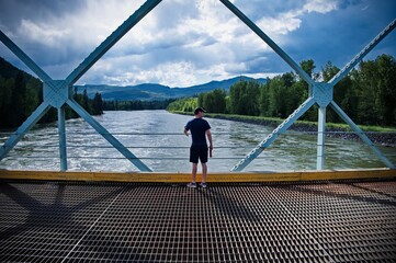 Mature man standing on the bridge
