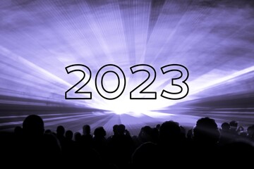 Happy new year 2023 purple laser show party people crowd. Luxury entertainment with audience silhouettes turn of the year celebration. Premium nightlife event at holidays season party time