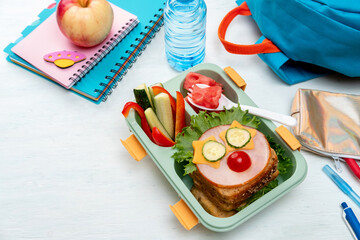 School lunch box for kids with food in the form of funny faces. School lunch box with sandwich,...