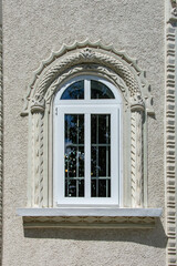Window modern frame in the medieval ornamental architecture.