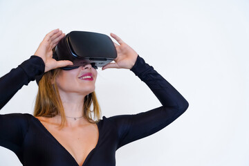 Woman with virtual reality glasses on white background, futuristic concept, metaverse, smiling holding the glasses