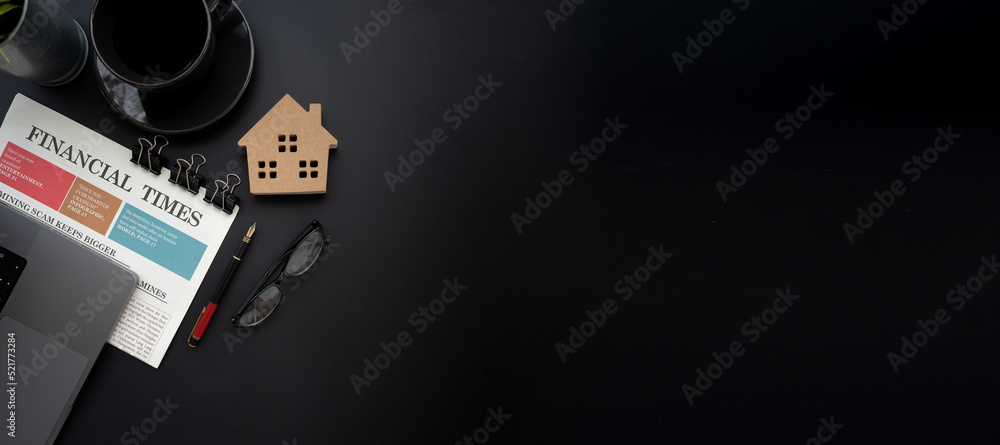 Fototapete Flat lay of top view desk work table with house model computer laptop and financial newspapaer in Real estate market concept includes copyspace for add text or graphic