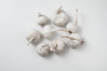 Garlic Cloves and Bulb on white table