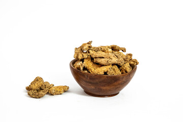 Dry ginger slices or zingiber officinale in bowl isolated on white background