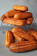 heap Creamy Eclairs. stack delicious  profiterole . Making desserts and sweets. Cream puffs. variety of desserts