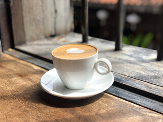 cup of coffee on wooden table