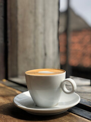 cup of coffee on wooden table