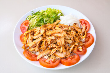 Turkish and Arabic Traditional Ramadan doner kebab with tasty tomato sauce and rice or turkish pilav in white plate on wood table background. ( , Iskender, ekmek arasi pilav ustu doner, doner durum )