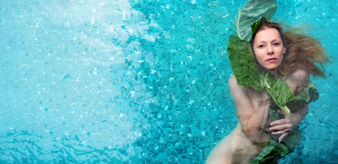 wide banner portrait of beautiful sexy naked woman in water with green wet leaf near face. soft...