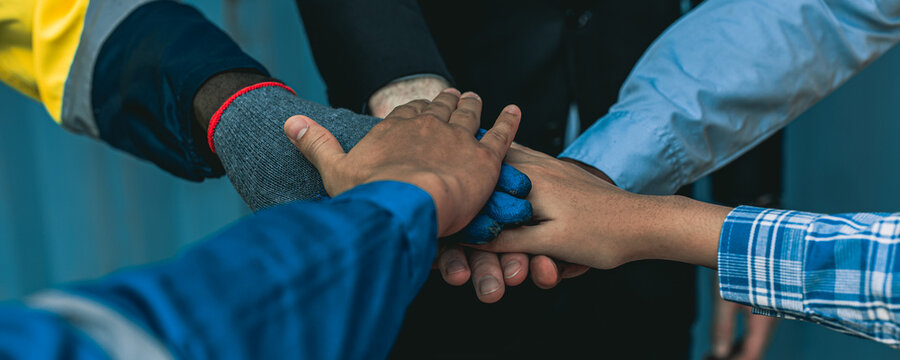 Container worker is putting hand together before starting their day. - Powered by Adobe