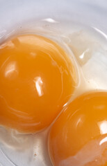 Egg yolks with whites in a glass bowl. Preparation of ingredients for baking a cake. Broken chicken eggs.