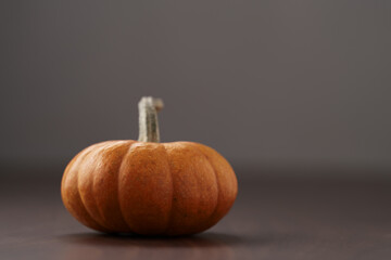 Cute orange pumpkin on wood table with copy space