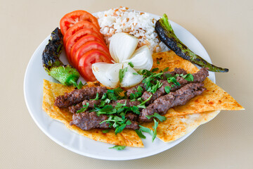 Beef steak grill with rice pilaf, fried potatoes, grilled pepper and tomatoes.Mix Platter with Beef rips, Cutlets, Potatoes and Sauces.