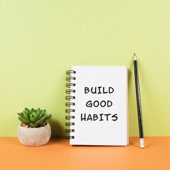 The words build good habits are standing on a notebook, change lifestyle, healthy and positive...