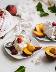 sweet dessert Pavlova cake with raspberries and cream peach