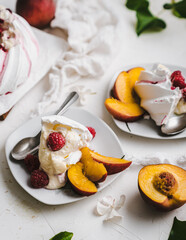 sweet dessert Pavlova cake with raspberries and cream peach