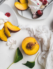 sweet dessert Pavlova cake with raspberries and cream peach