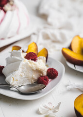 sweet dessert Pavlova cake with raspberries and cream peach