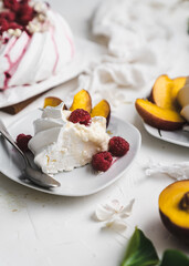 sweet dessert Pavlova cake with raspberries and cream peach