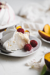 sweet dessert Pavlova cake with raspberries and cream peach