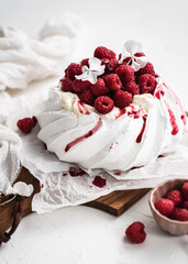 sweet dessert Pavlova cake with raspberries and cream peach
