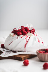 sweet dessert Pavlova cake with raspberries and cream peach