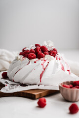 sweet dessert Pavlova cake with raspberries and cream peach