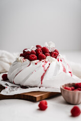 sweet dessert Pavlova cake with raspberries and cream peach
