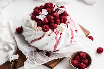 sweet dessert Pavlova cake with raspberries and cream peach
