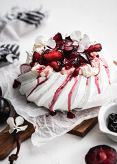 dessert Pavlova cake with cherry plum