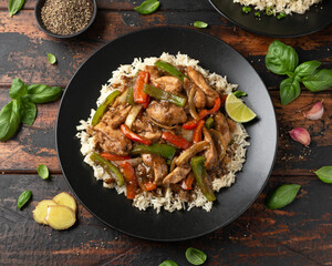 Stir fry pepper chicken with sweet peppers, onion, garlic and ginger