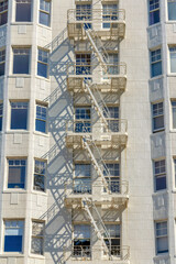 Emergency stairs in the middle of bay windows of a tall apartment building at San Francisco, CA