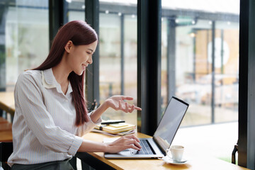 Portrait of a business woman using a computer to work on financial statements