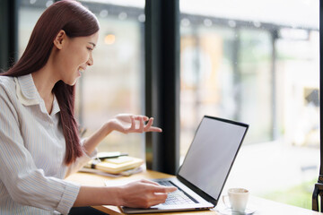 Portrait of a business woman using a computer to work on financial statements