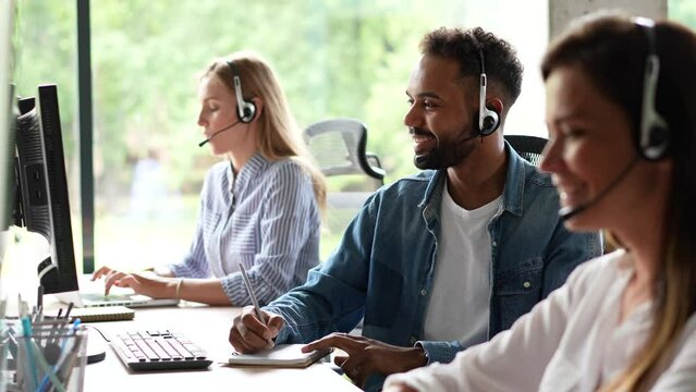 Male representative call center agent in wireless headset helping client, operator working in customer support service - Powered by Adobe