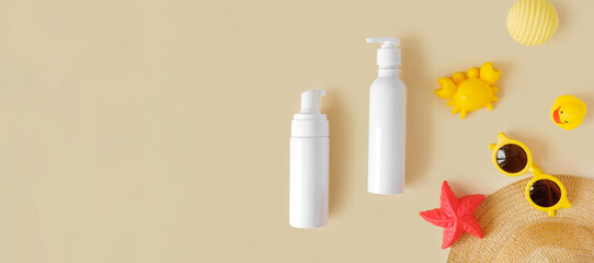 Sunscreen lotion tube on neutral background. Plastic bottle of sun protection and kids sunglasses...