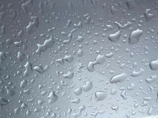 Water drops on a silver metallic surface