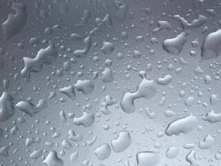 Water drops on a silver metallic surface