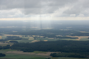 Summer aerial photo from shout west part of Finland. Sun trays (god fingers) down from the clouds. 