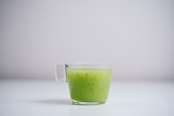 Kiwi and green apple blended fruit juice with isolated white background.