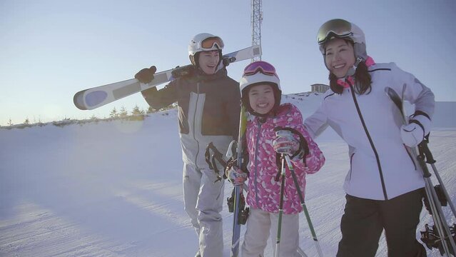 Happy young family relaxing in ski resort,4K
