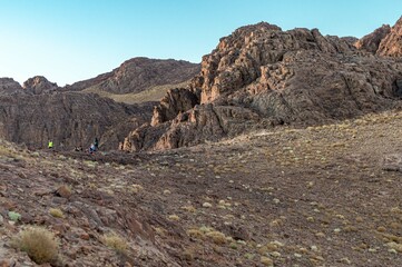 Group of people on peak mountain climbing helping team work
