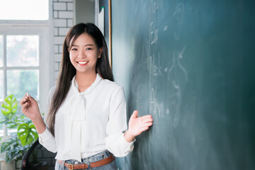Portrait attractive of smiling Asian Teacher woman present or teaching student in english...