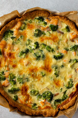 Homemade pie with red fish and broccoli, quiche with salmon and char, cheese and cream