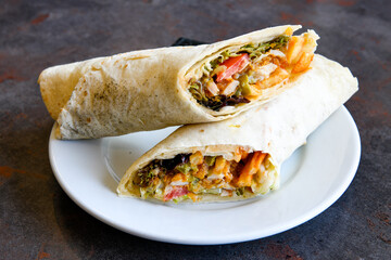 Lavash doner kebab ( zurna tavuk et doner durum )  or shawarma sliced in plate isolated. 