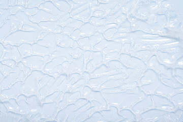 Transparent liquid Gel serum texture on blue background. Make-up and cosmetics texture background, skincare product and beauty gel