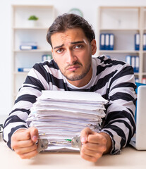 Young employee feeling like prisoner at work