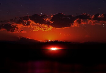 night sunset at sea dramatic cloudy sky with gold sunbeams